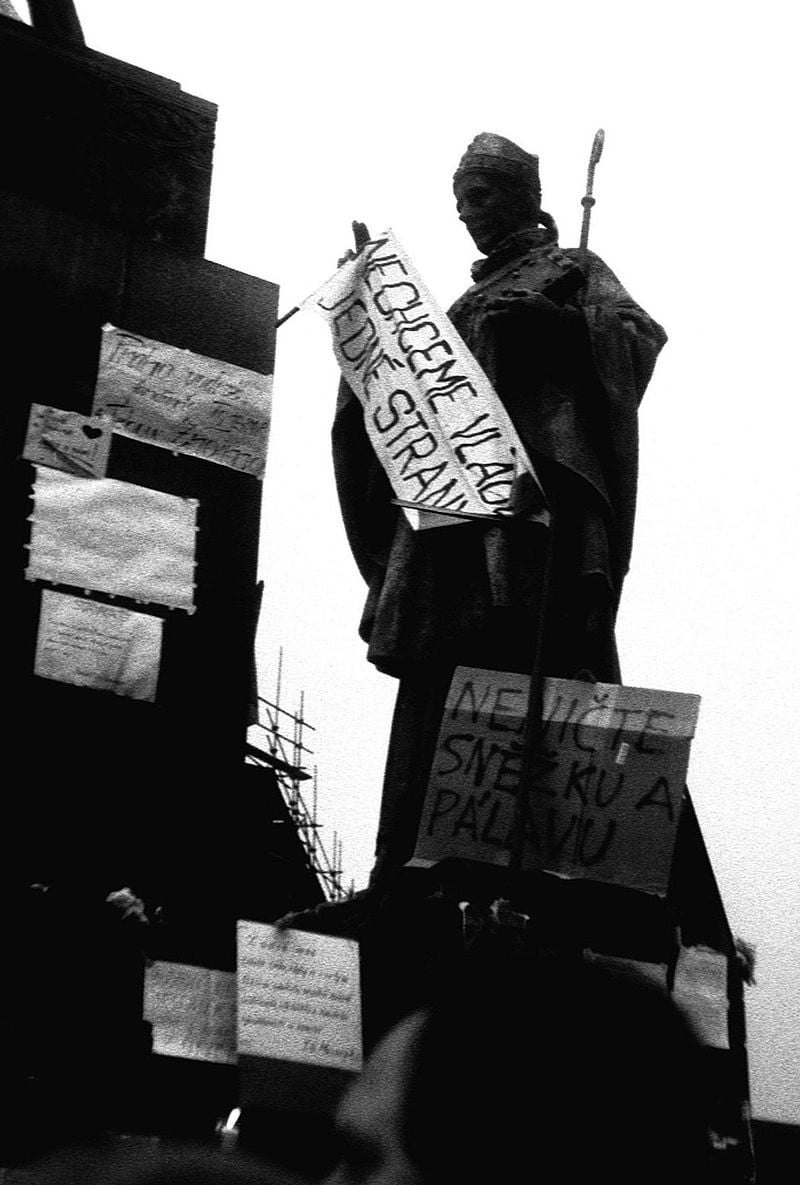 A statue of Saint Adalbert of Prague with a streamer and banners